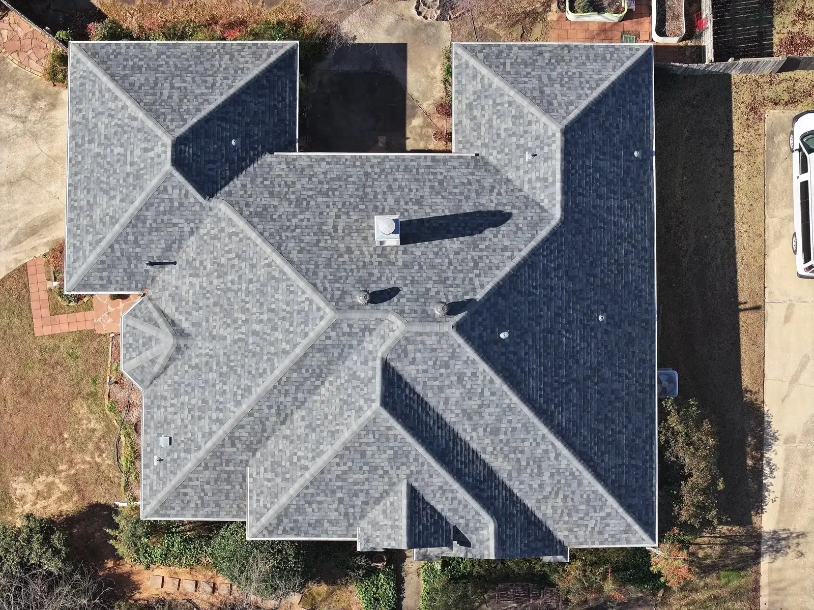 Top-down drone photo of a completed hip roof replacement